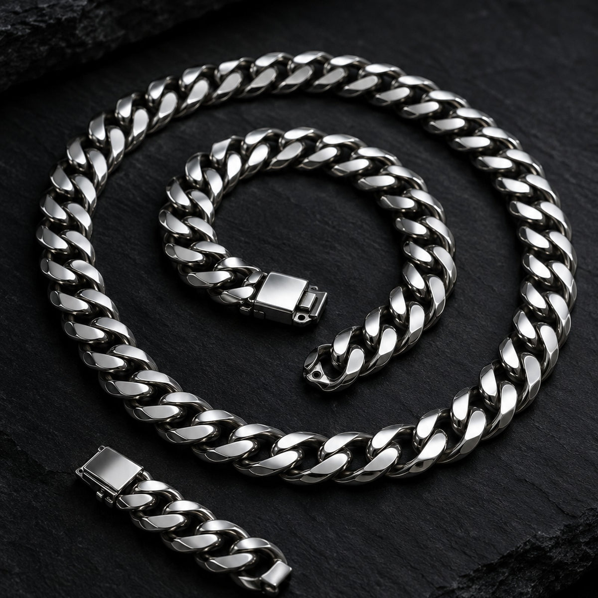 Polished stainless steel Cuban link chain necklace on black slate
